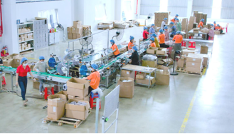 Factory team assembling and packing products