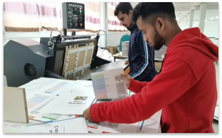 Operators reviewing printed product components